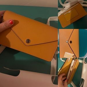 BRAND NEW Michael Kors in the color Ember. Still has original packaging